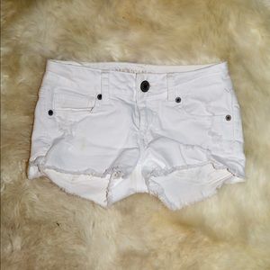 White ripped shorts